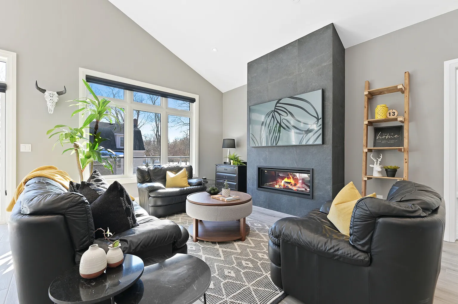 Living room with tiled fireplace wall and vaulted ceiling